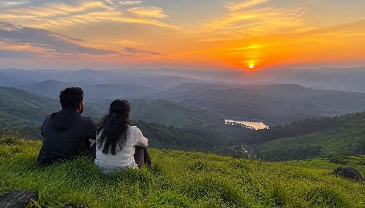 Couple watching the sunset over the hills of Vagamon