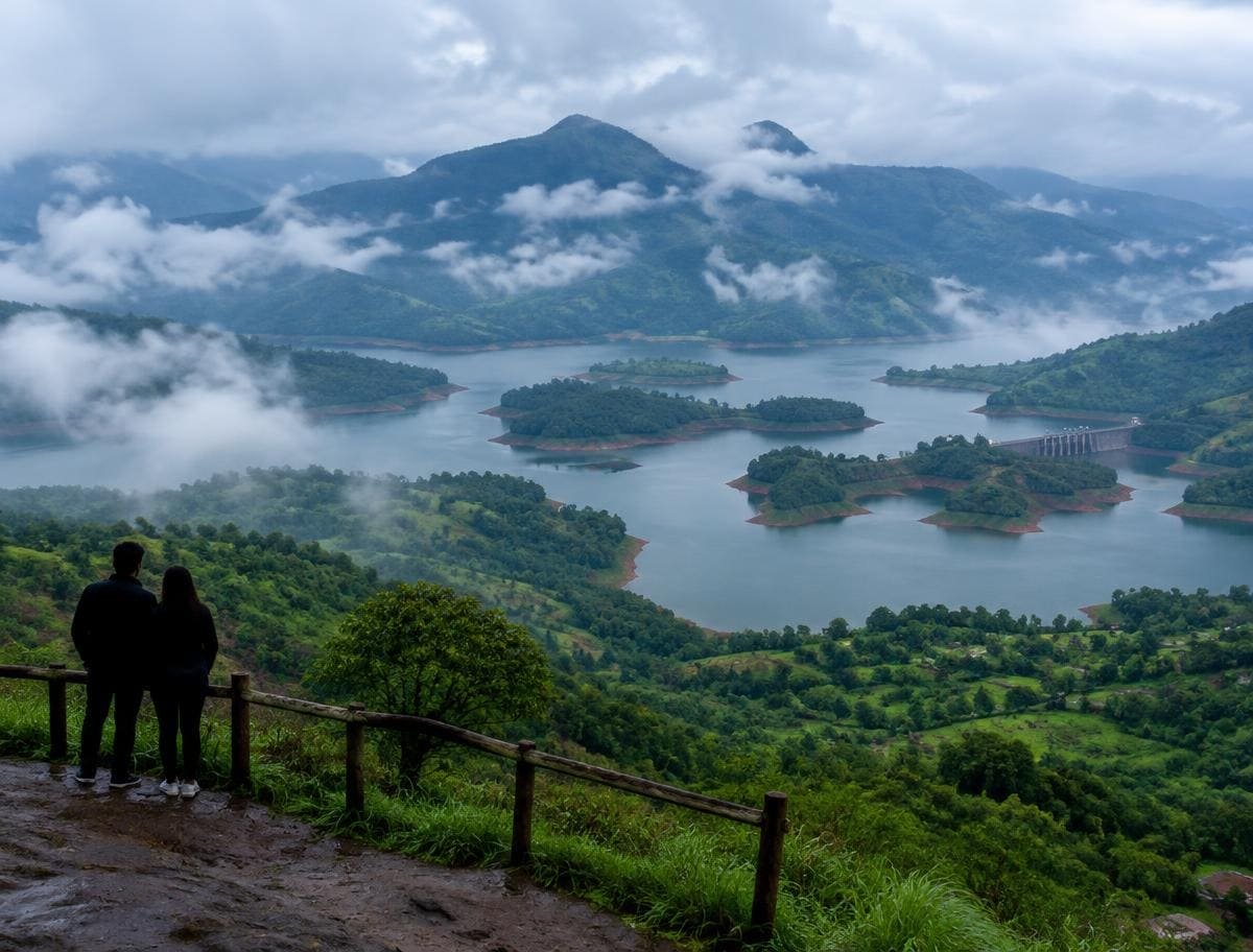 Couple at a misty Wayanad viewpoint above the Banasura reservoir islands